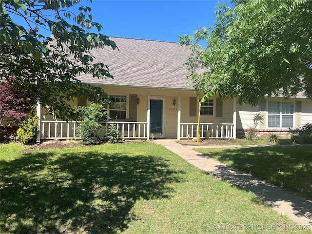 2702 Raintree Cir, Sapulpa, OK 74066 - view of front facade featuring roof with shingles, a porch, and a front lawn