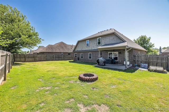 2405 S 13th St, Broken Arrow, OK 74012 - back of property with a patio area, a fire pit, and brick siding