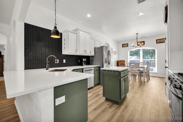 2405 S 13th St, Broken Arrow, OK 74012 - kitchen featuring green cabinets, a sink, stainless steel appliances, white cabinets, and light wood-style flooring