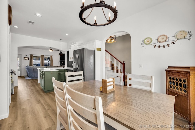 2405 S 13th St, Broken Arrow, OK 74012 - dining space with arched walkways, a chandelier, ceiling fan, light wood-type flooring, and recessed lighting