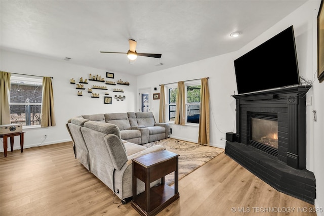 2405 S 13th St, Broken Arrow, OK 74012 - living area with light wood finished floors, a brick fireplace, ceiling fan, and baseboards