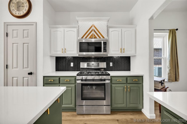2405 S 13th St, Broken Arrow, OK 74012 - kitchen featuring green cabinetry, stainless steel appliances, white cabinetry, and light countertops