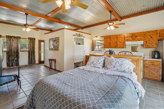 36105 S 4202nd Rd, Inola, OK 74036 - bedroom with beamed ceiling, light tile patterned floors, and baseboards