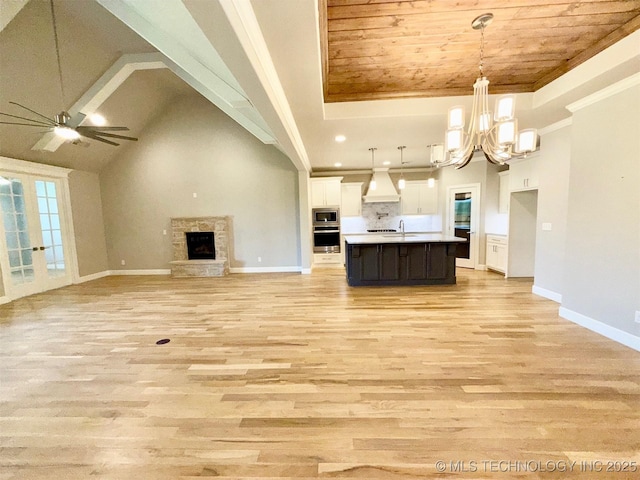 14503 E 80th St N, Owasso, OK 74055 - unfurnished living room with a chandelier, wooden ceiling, baseboards, light wood-type flooring, and crown molding