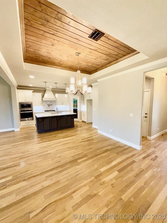 14503 E 80th St N, Owasso, OK 74055 - kitchen featuring a raised ceiling, wooden ceiling, a chandelier, appliances with stainless steel finishes, and open floor plan