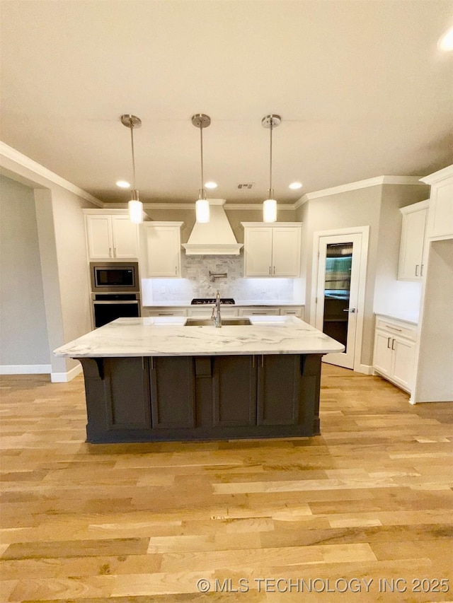 14503 E 80th St N, Owasso, OK 74055 - kitchen with appliances with stainless steel finishes, premium range hood, crown molding, white cabinetry, and backsplash