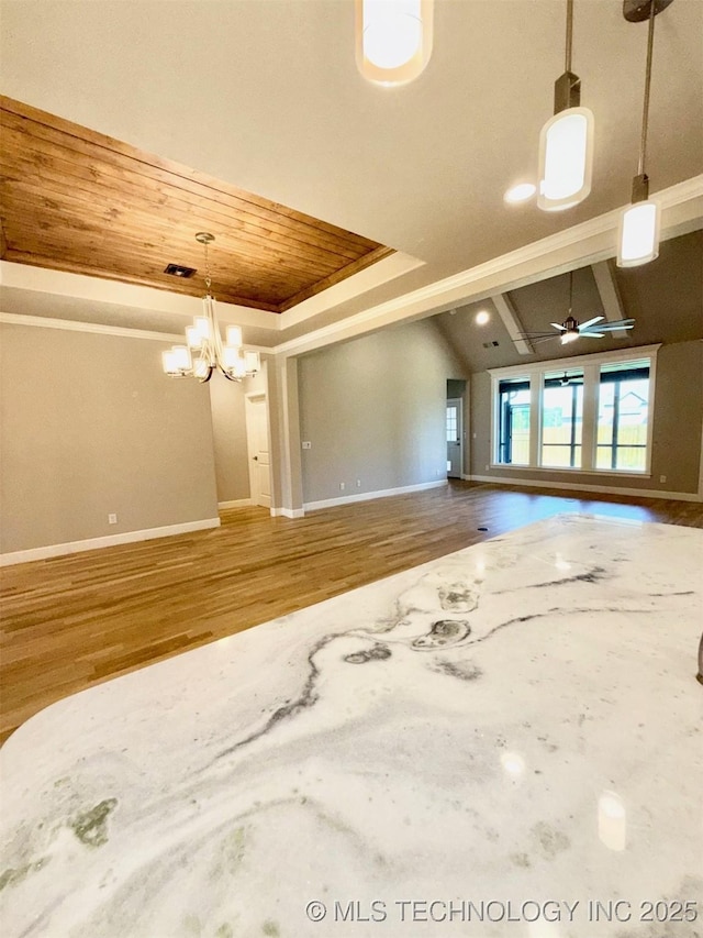14503 E 80th St N, Owasso, OK 74055 - unfurnished living room featuring wood ceiling, baseboards, a chandelier, wood finished floors, and a raised ceiling