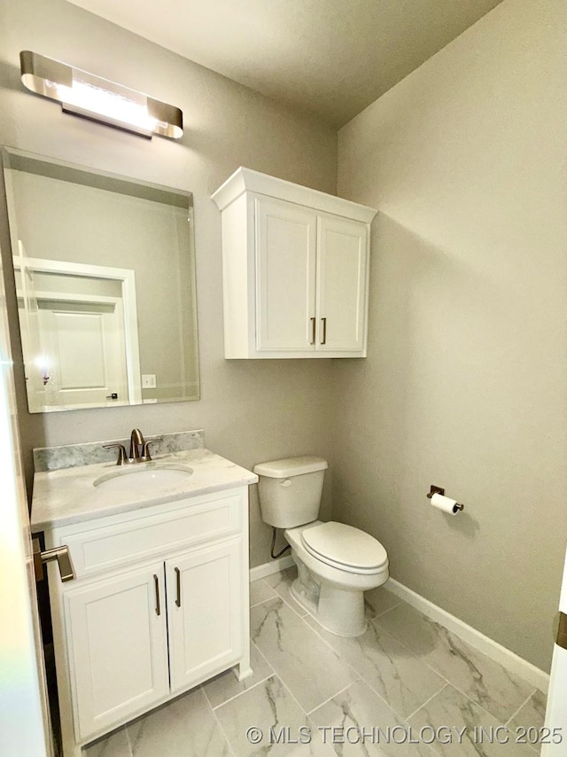 14503 E 80th St N, Owasso, OK 74055 - half bath featuring baseboards, marble finish floors, toilet, and vanity
