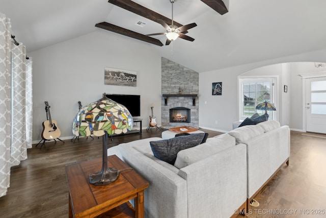 23012 E 104th St S, Broken Arrow, OK 74014 - living area with a stone fireplace, a ceiling fan, wood finished floors, arched walkways, and baseboards