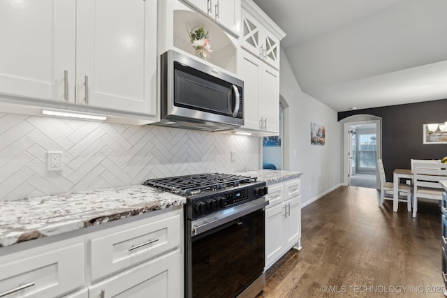 23012 E 104th St S, Broken Arrow, OK 74014 - kitchen with appliances with stainless steel finishes, arched walkways, tasteful backsplash, light stone counters, and white cabinetry