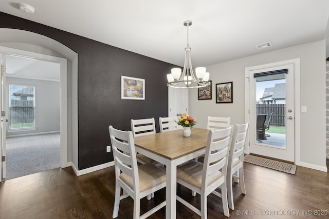 23012 E 104th St S, Broken Arrow, OK 74014 - dining space featuring healthy amount of natural light, dark wood-type flooring, a chandelier, and baseboards