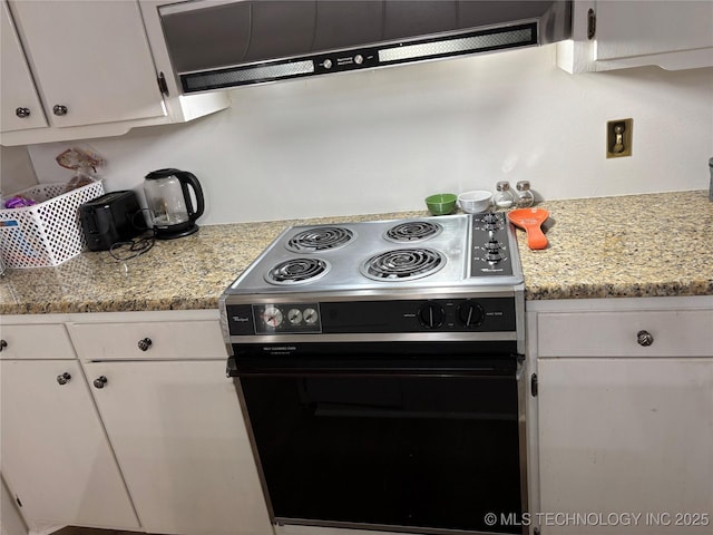 1113 S Meadow Dr, Ardmore, OK 73401 - kitchen with electric range, white cabinetry, and under cabinet range hood