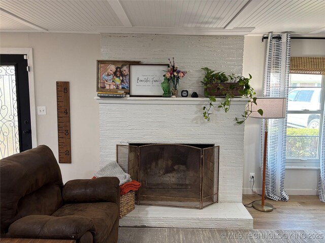 1113 S Meadow Dr, Ardmore, OK 73401 - detailed view of wood finished floors, crown molding, a large fireplace, and baseboards