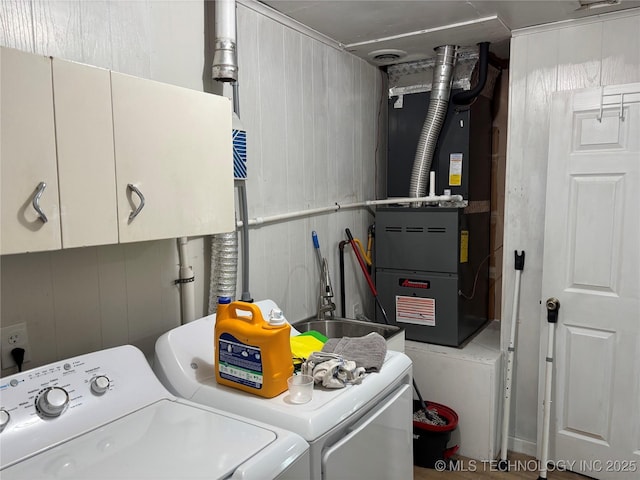 1113 S Meadow Dr, Ardmore, OK 73401 - washroom featuring washing machine and dryer, cabinet space, and heating unit