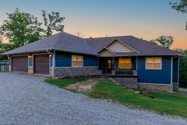 11802 Hickory Ln, Claremore, OK 74017 - view of front of home featuring a shingled roof, stone siding, gravel driveway, and a porch