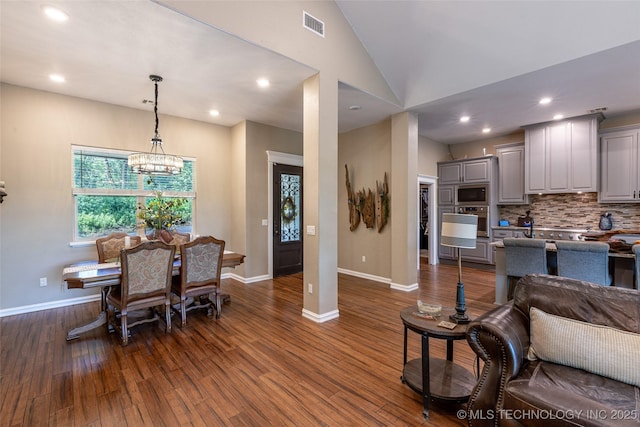 11802 Hickory Ln, Claremore, OK 74017 - dining space with dark wood-style floors, lofted ceiling, a chandelier, and recessed lighting