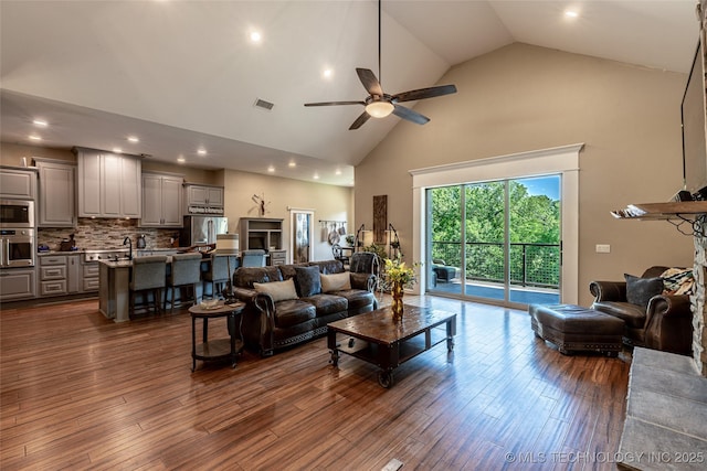 11802 Hickory Ln, Claremore, OK 74017 - living room featuring high vaulted ceiling, ceiling fan, dark wood finished floors, and recessed lighting