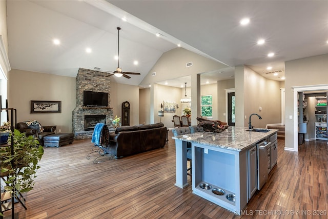 11802 Hickory Ln, Claremore, OK 74017 - kitchen with open floor plan, dark wood finished floors, light stone countertops, ceiling fan, and recessed lighting