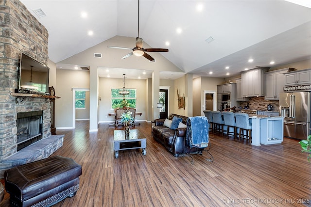 11802 Hickory Ln, Claremore, OK 74017 - living room with ceiling fan, dark wood-type flooring, recessed lighting, high vaulted ceiling, and a fireplace