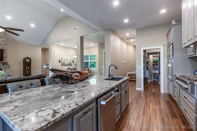 11802 Hickory Ln, Claremore, OK 74017 - kitchen with open floor plan, ceiling fan, dark wood-style floors, gray cabinets, and a large island with sink