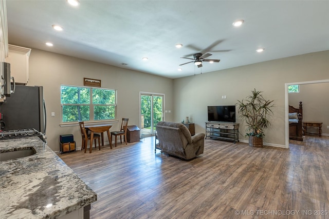 11802 Hickory Ln, Claremore, OK 74017 - living room featuring dark wood-style flooring, ceiling fan, and recessed lighting