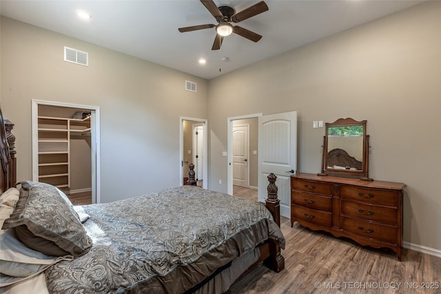11802 Hickory Ln, Claremore, OK 74017 - bedroom with a high ceiling, wood finished floors, a spacious closet, recessed lighting, and a closet