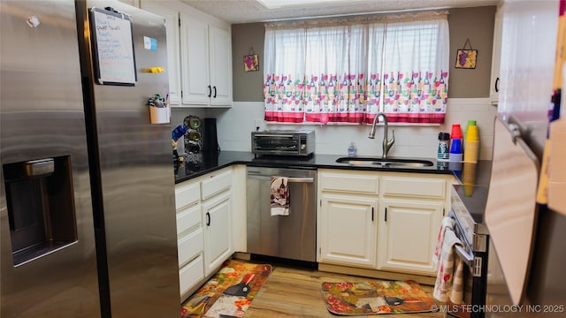 5209 SE Nowata Rd Unit 104B, Bartlesville, OK 74006 - kitchen featuring stainless steel appliances, a sink, dark countertops, and plenty of natural light
