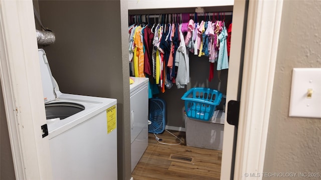 5209 SE Nowata Rd Unit 104B, Bartlesville, OK 74006 - washroom with separate washer and dryer and wood finished floors