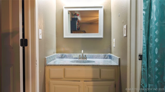 5209 SE Nowata Rd Unit 104B, Bartlesville, OK 74006 - bathroom featuring vanity and a textured wall
