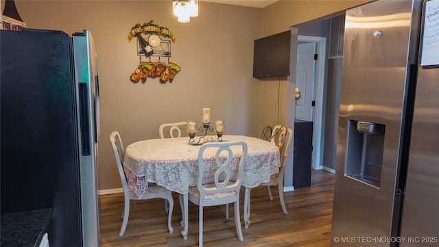 5209 SE Nowata Rd Unit 104B, Bartlesville, OK 74006 - dining area with wood finished floors and baseboards