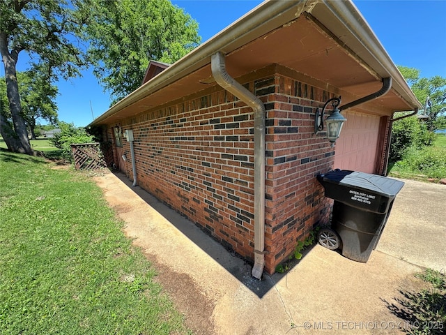 50 Fairway, Burneyville, OK 73430 - view of side of property featuring a yard, brick siding, and an attached garage