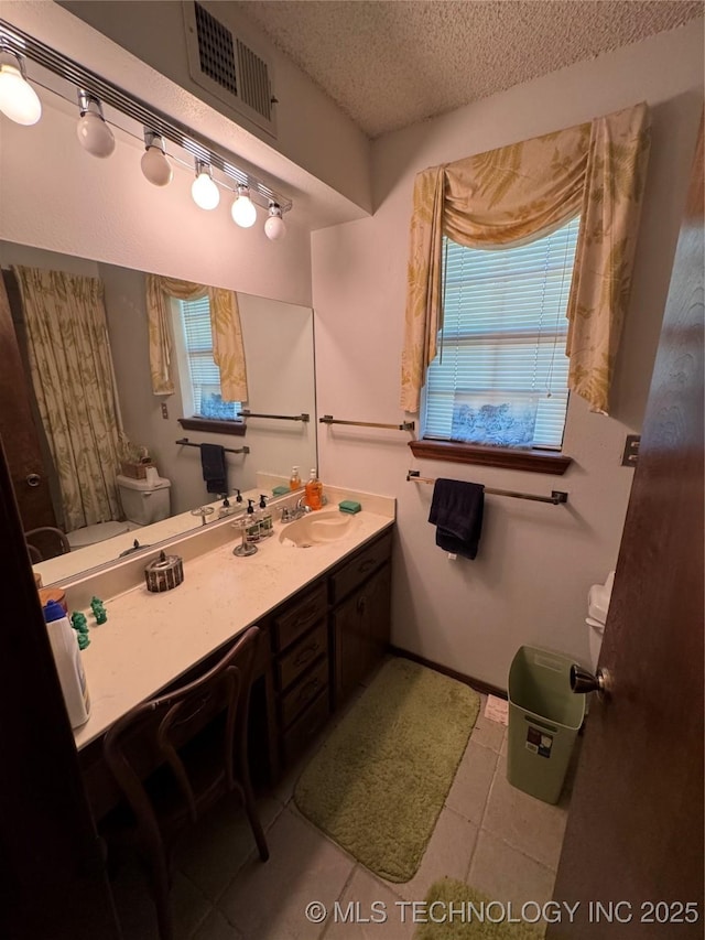 50 Fairway, Burneyville, OK 73430 - bathroom featuring toilet, a textured ceiling, vanity, and tile patterned flooring