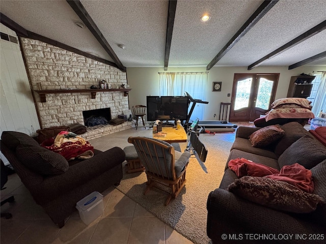 50 Fairway, Burneyville, OK 73430 - tiled living area featuring beamed ceiling, a textured ceiling, and a stone fireplace