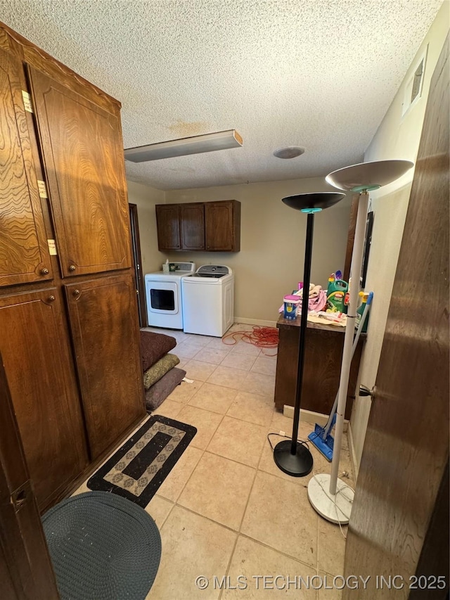 50 Fairway, Burneyville, OK 73430 - kitchen featuring washing machine and dryer, a textured ceiling, light tile patterned floors, and baseboards