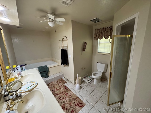 50 Fairway, Burneyville, OK 73430 - full bathroom featuring a bath, toilet, ceiling fan, double vanity, and tile patterned floors