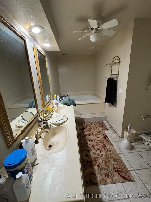 50 Fairway, Burneyville, OK 73430 - bathroom featuring a tub, ceiling fan, tile patterned flooring, vanity, and baseboards