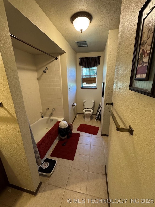 50 Fairway, Burneyville, OK 73430 - full bath with a textured wall, toilet, tile patterned floors, a textured ceiling, and bathing tub / shower combination
