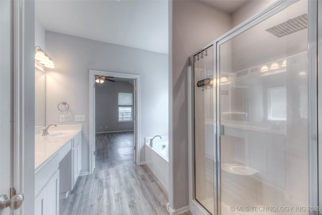 25363 E 87th St S, Broken Arrow, OK 74014 - bathroom featuring double vanity, a stall shower, a bath, wood finished floors, and ceiling fan