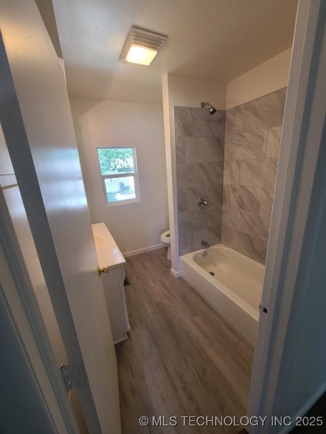 700 S Apple St, Sapulpa, OK 74066 - full bath featuring toilet, vanity, wood finished floors,  shower combination, and baseboards