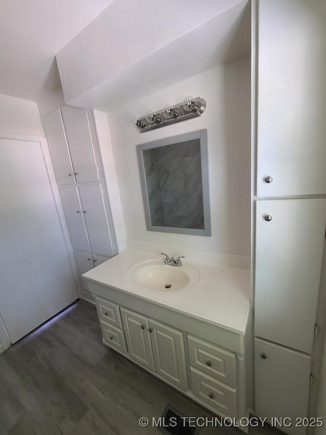 700 S Apple St, Sapulpa, OK 74066 - bathroom featuring vanity and wood finished floors