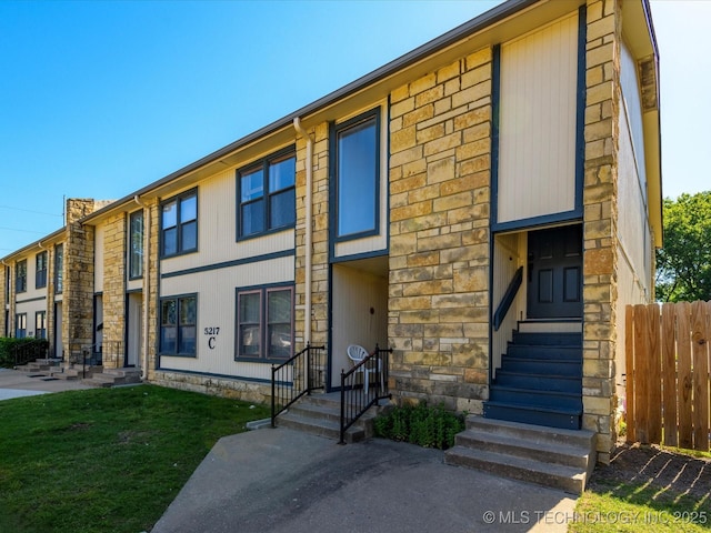 5217 Nowata Rd Unit C204, Bartlesville, OK 74006 - townhome / multi-family property featuring entry steps and stone siding