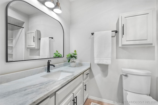 1602 N Hickory Ave, Broken Arrow, OK 74012 - bathroom with vanity, toilet, baseboards, wood finished floors, and a shower