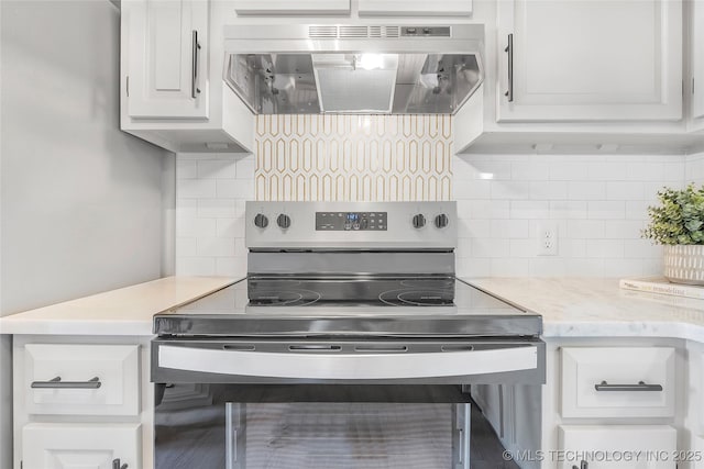 1602 N Hickory Ave, Broken Arrow, OK 74012 - kitchen featuring wall chimney exhaust hood, electric range, tasteful backsplash, and white cabinetry