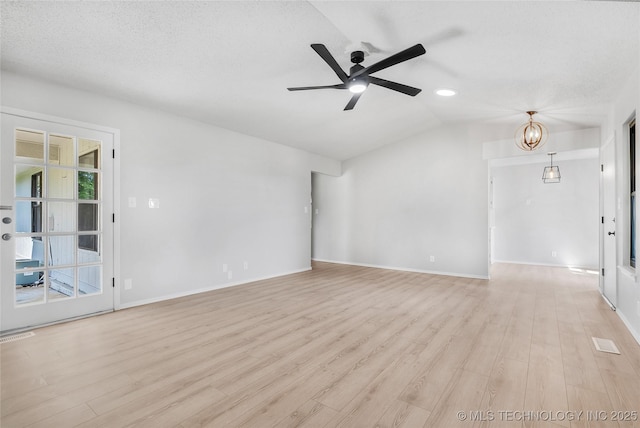 1602 N Hickory Ave, Broken Arrow, OK 74012 - empty room with light wood-style floors, ceiling fan, a chandelier, baseboards, and a textured ceiling