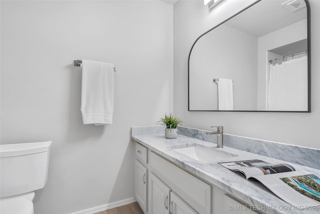 1602 N Hickory Ave, Broken Arrow, OK 74012 - bathroom featuring vanity, toilet, wood finished floors, and baseboards
