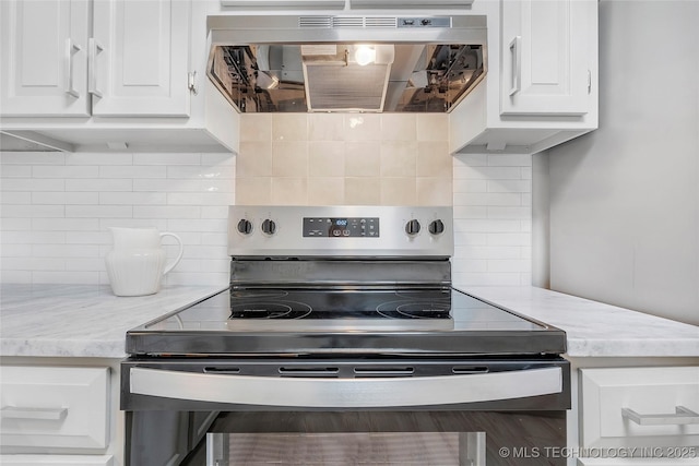 1602 N Hickory Ave, Broken Arrow, OK 74012 - kitchen with stainless steel electric range, extractor fan, decorative backsplash, white cabinetry, and light stone counters
