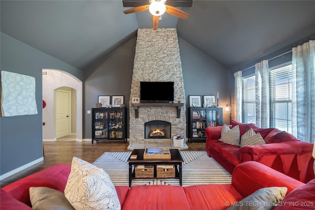 18409 E 50th Pl S, Tulsa, OK 74134 - living room featuring a ceiling fan, arched walkways, wood finished floors, baseboards, and a fireplace