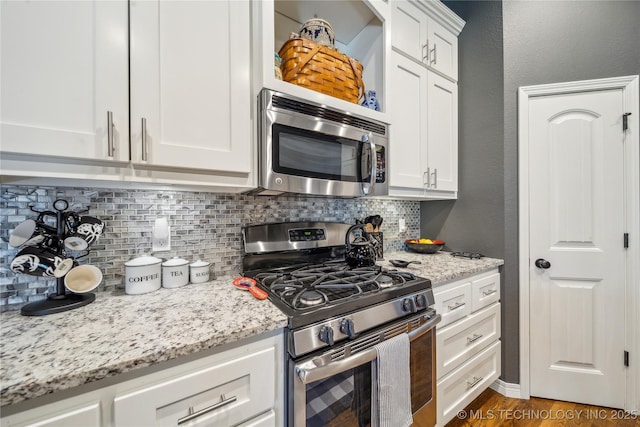 18409 E 50th Pl S, Tulsa, OK 74134 - kitchen with stainless steel appliances, tasteful backsplash, white cabinets, and light stone counters