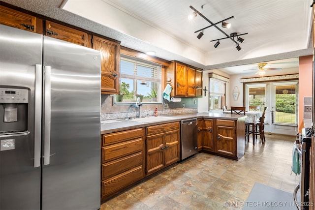 20700 E 420th Rd, Claremore, OK 74017 - kitchen featuring appliances with stainless steel finishes, a peninsula, a raised ceiling, and plenty of natural light