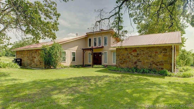 20700 E 420th Rd, Claremore, OK 74017 - rear view of property featuring stone siding, a lawn, and a metal roof